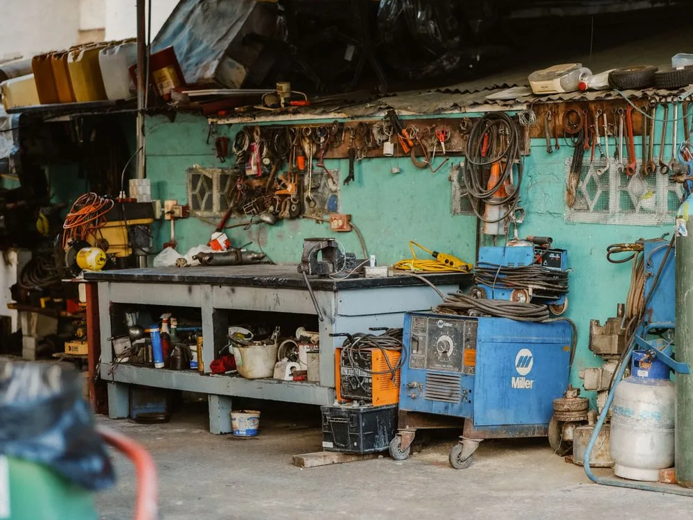 Inside view of motor repair workshop floor with machinery and testing stations