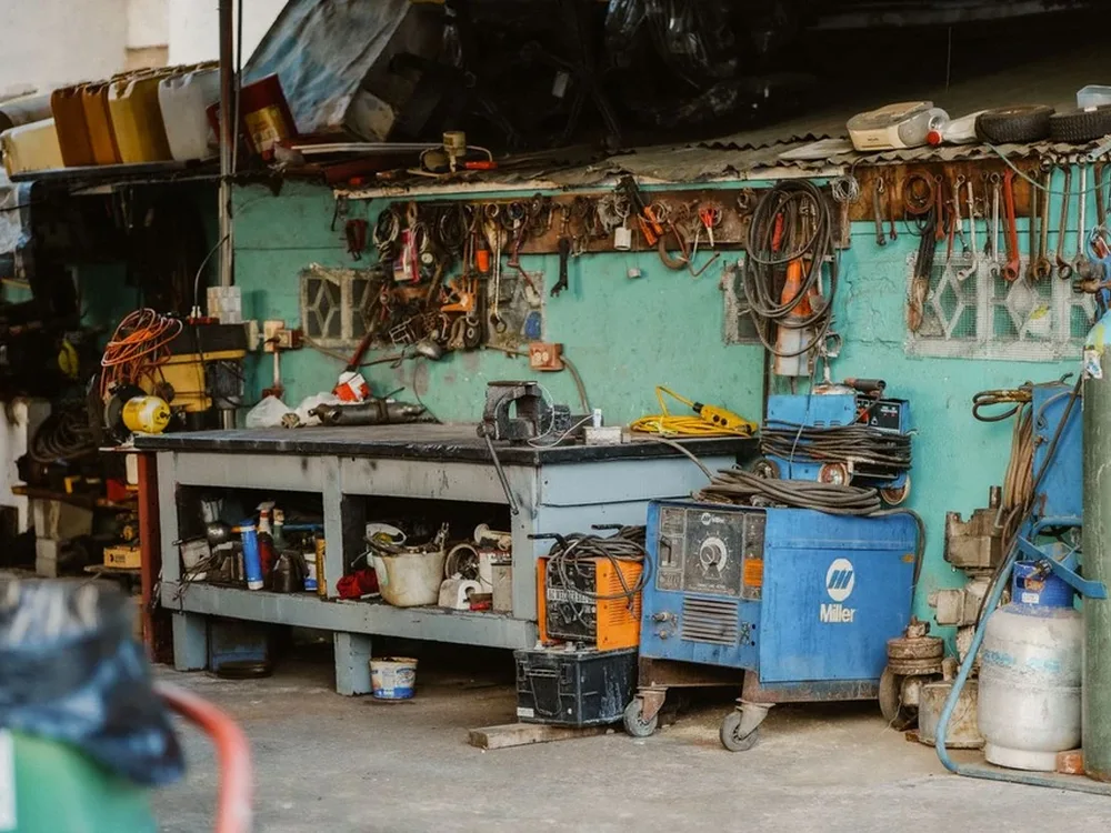 Equipped electronics and motor repair workbench with tools and testing gear